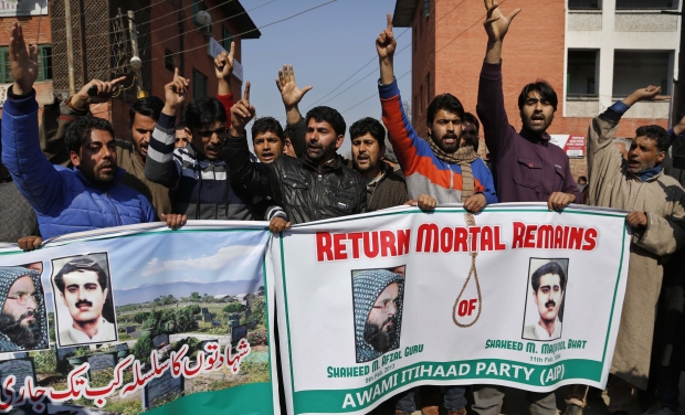 Kashmiri activists of Awami Itihaad party shout slogans as they hold banners with photographs of pro-independence leader Mohammed Maqbool Butt, right and former Kashmiri rebel Mohammed Afzal Guru during a protest in Srinagar (Photo: AP) Kashmiri activists of Awami Itihaad party shout slogans as they hold banners with photographs of pro-independence leader Mohammed Maqbool Butt, right and former Kashmiri rebel Mohammed Afzal Guru during a protest in Srinagar (Photo: AP)